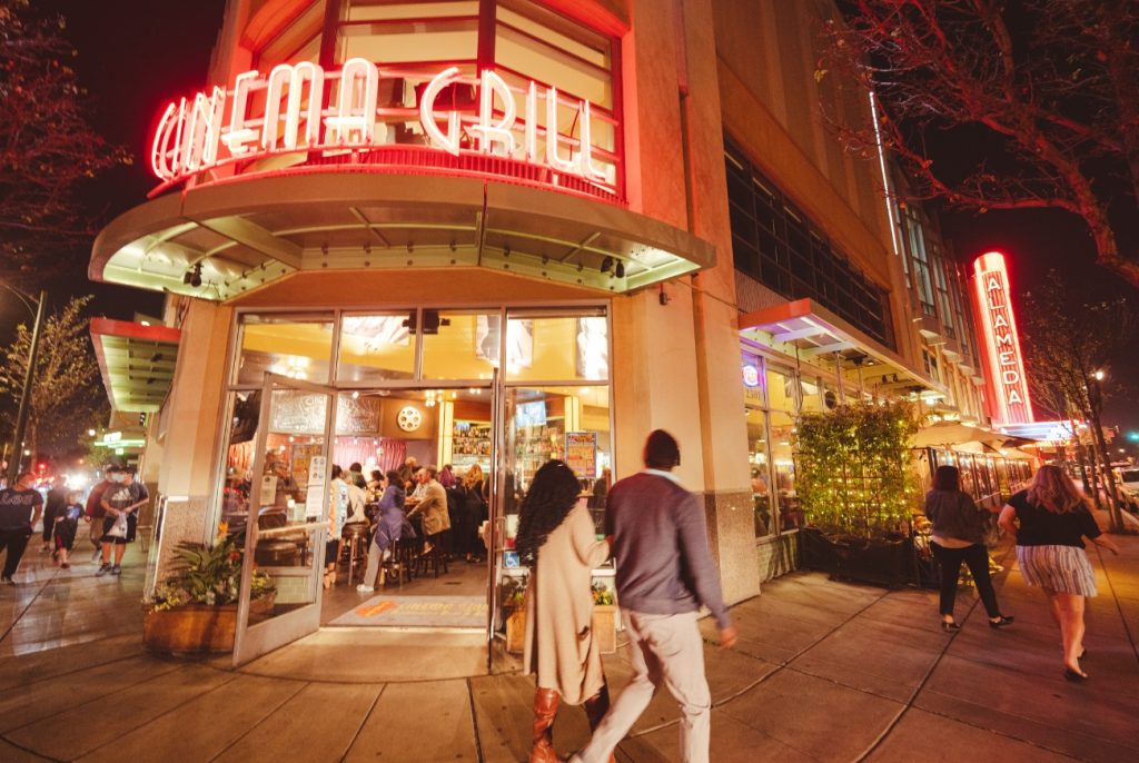 People walking outside Alameda Cinema Grill exterior view