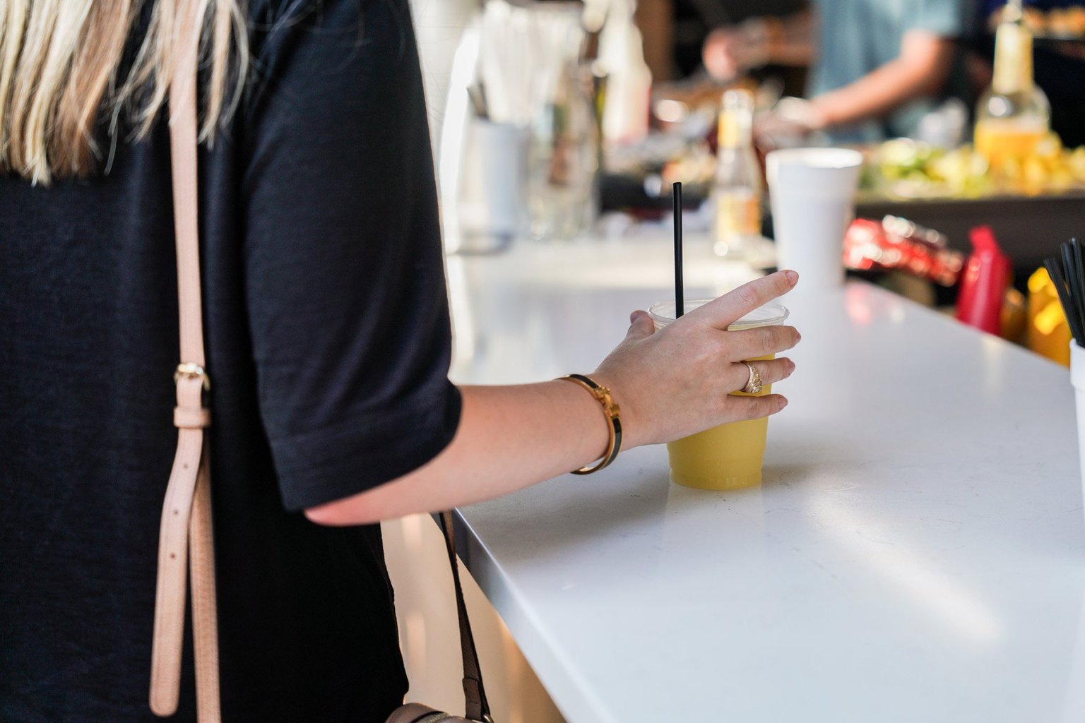 girl holding a drink at a bar
