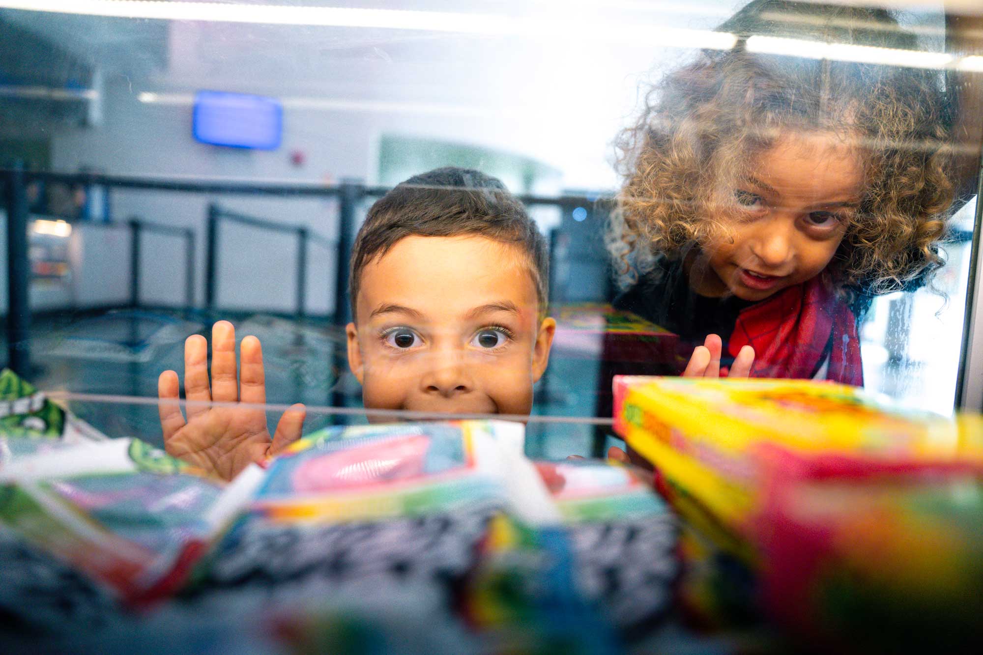 Kids peering through window at concessions
