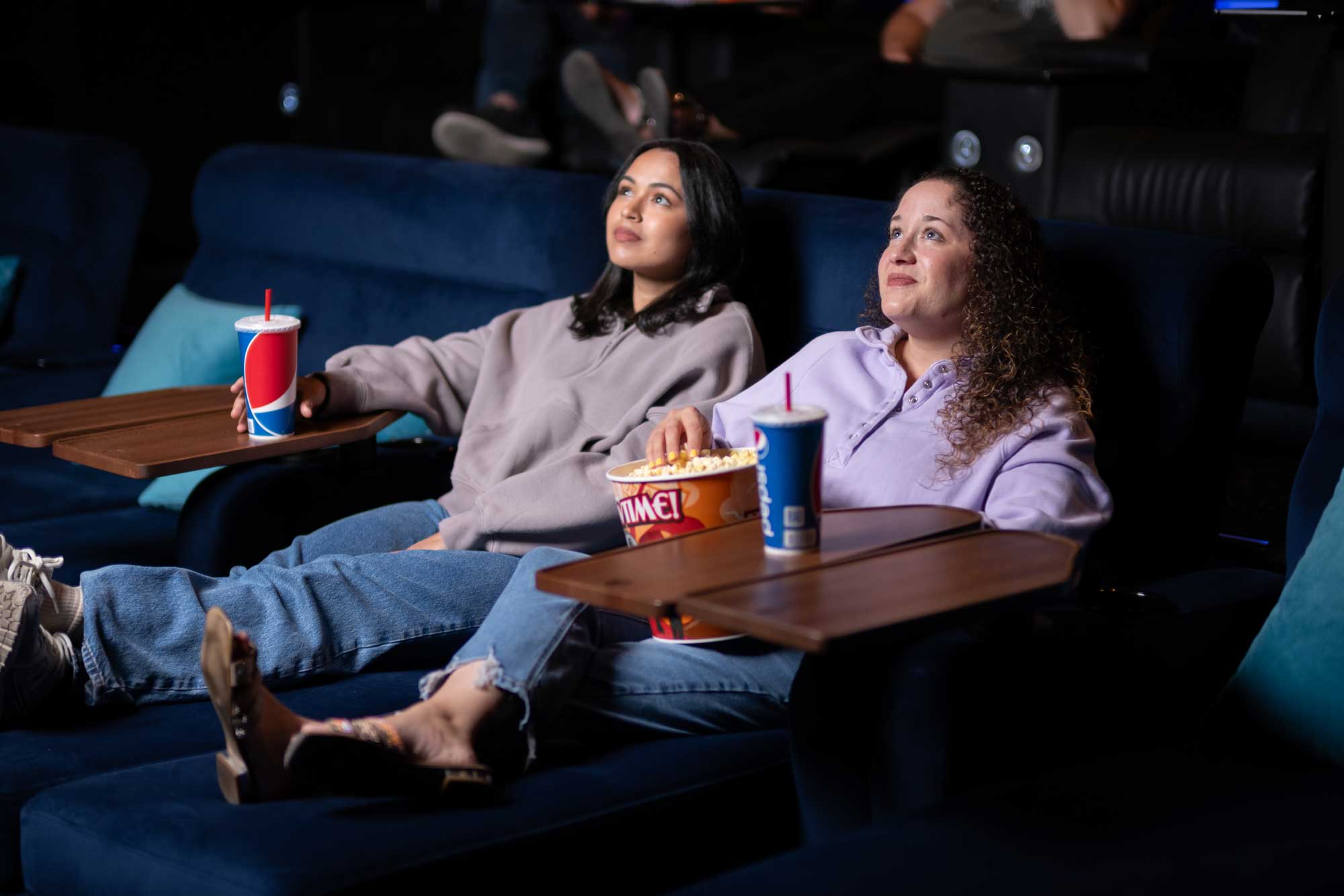 Women watching movie on day beds