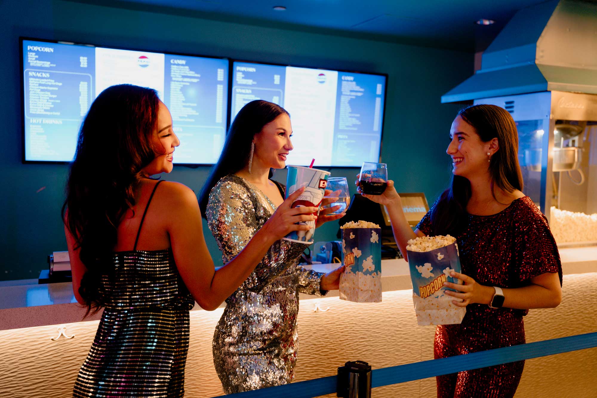 Woman with drinks and popcorn at concessions counter