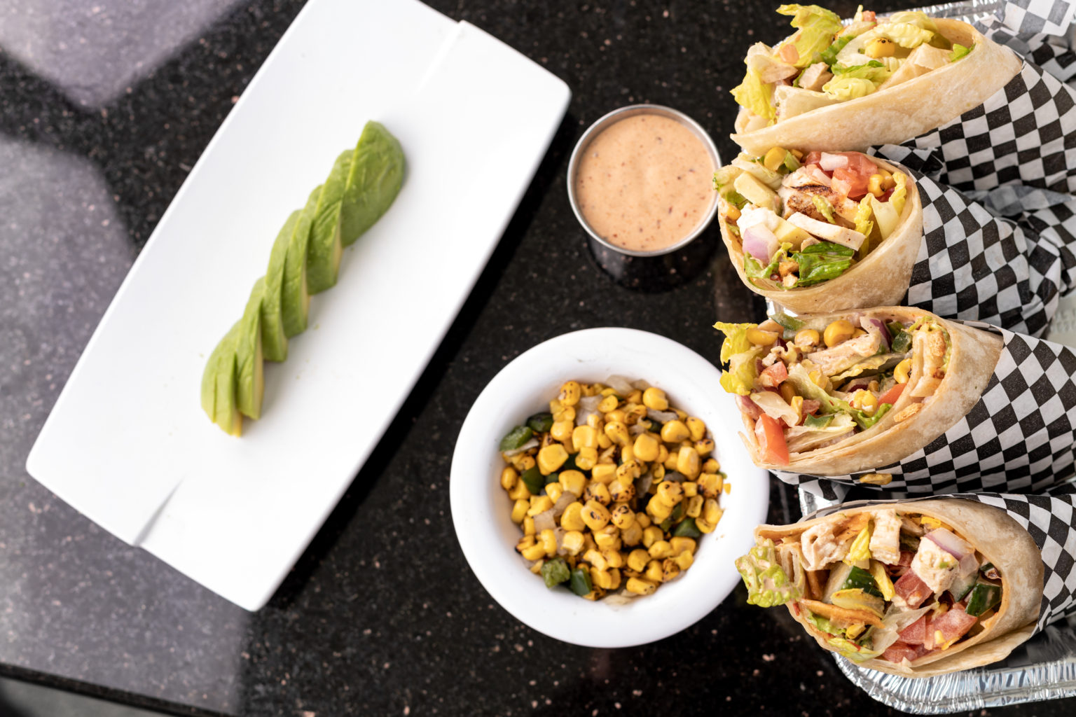 Southwest chicken wraps with avocado, corn and dipping sauce
