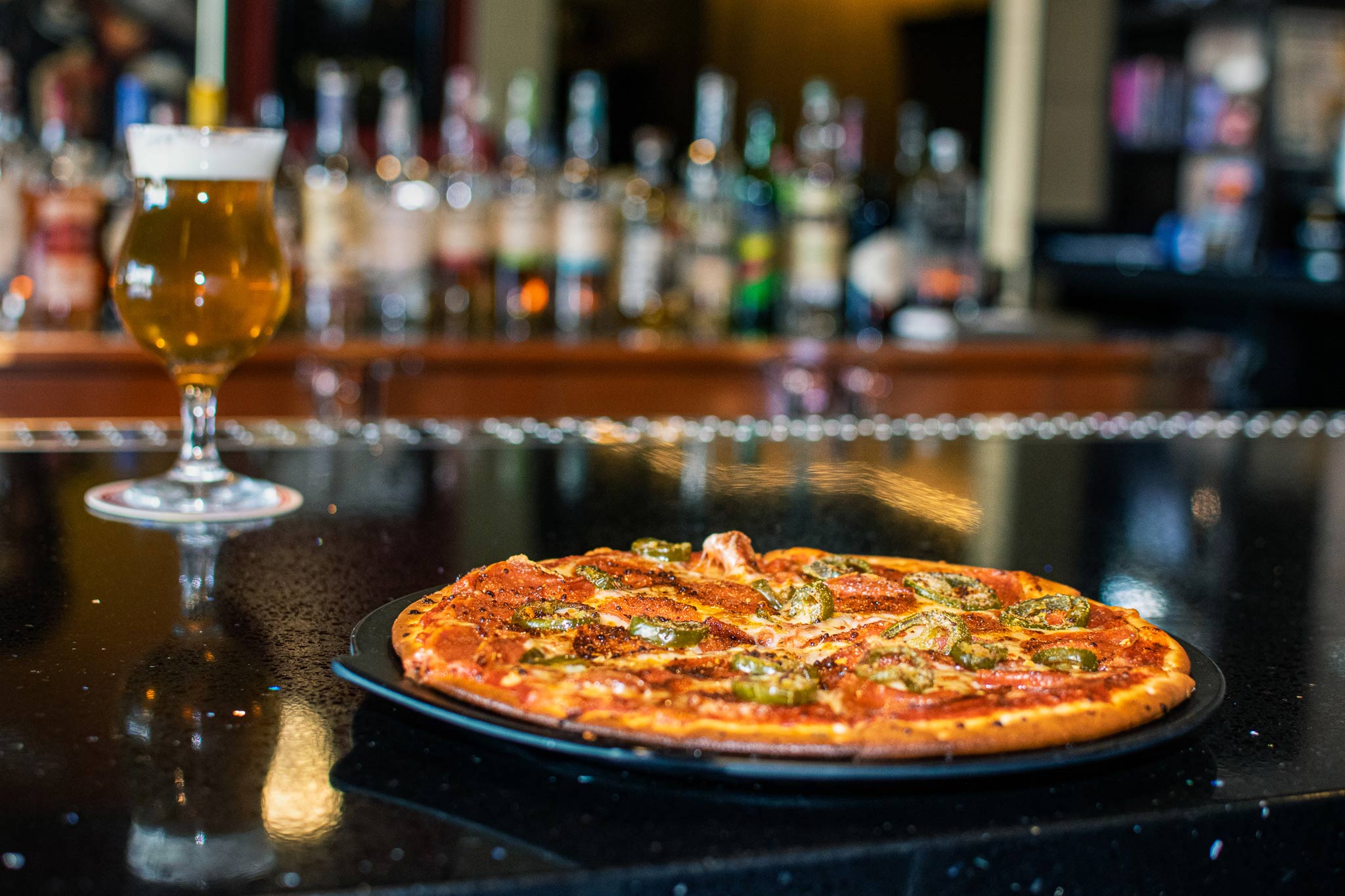 Pizza and beer on a bar counter