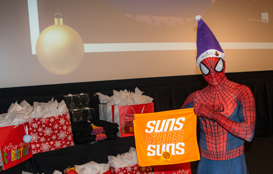 Spiderman holding Suns flag in front of gift bags