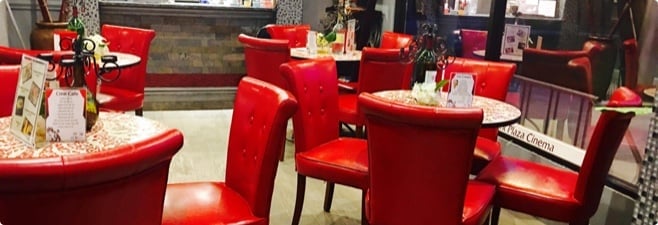 Small tables with red chairs and decor