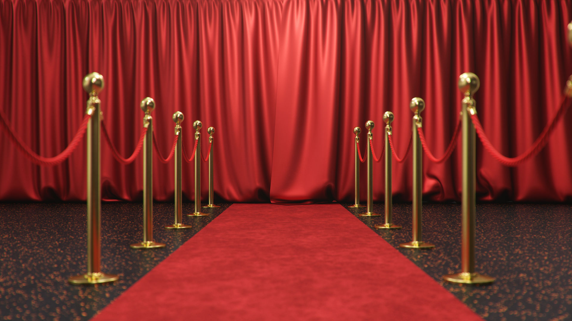 Red carpet with velvet ropes and red curtains
