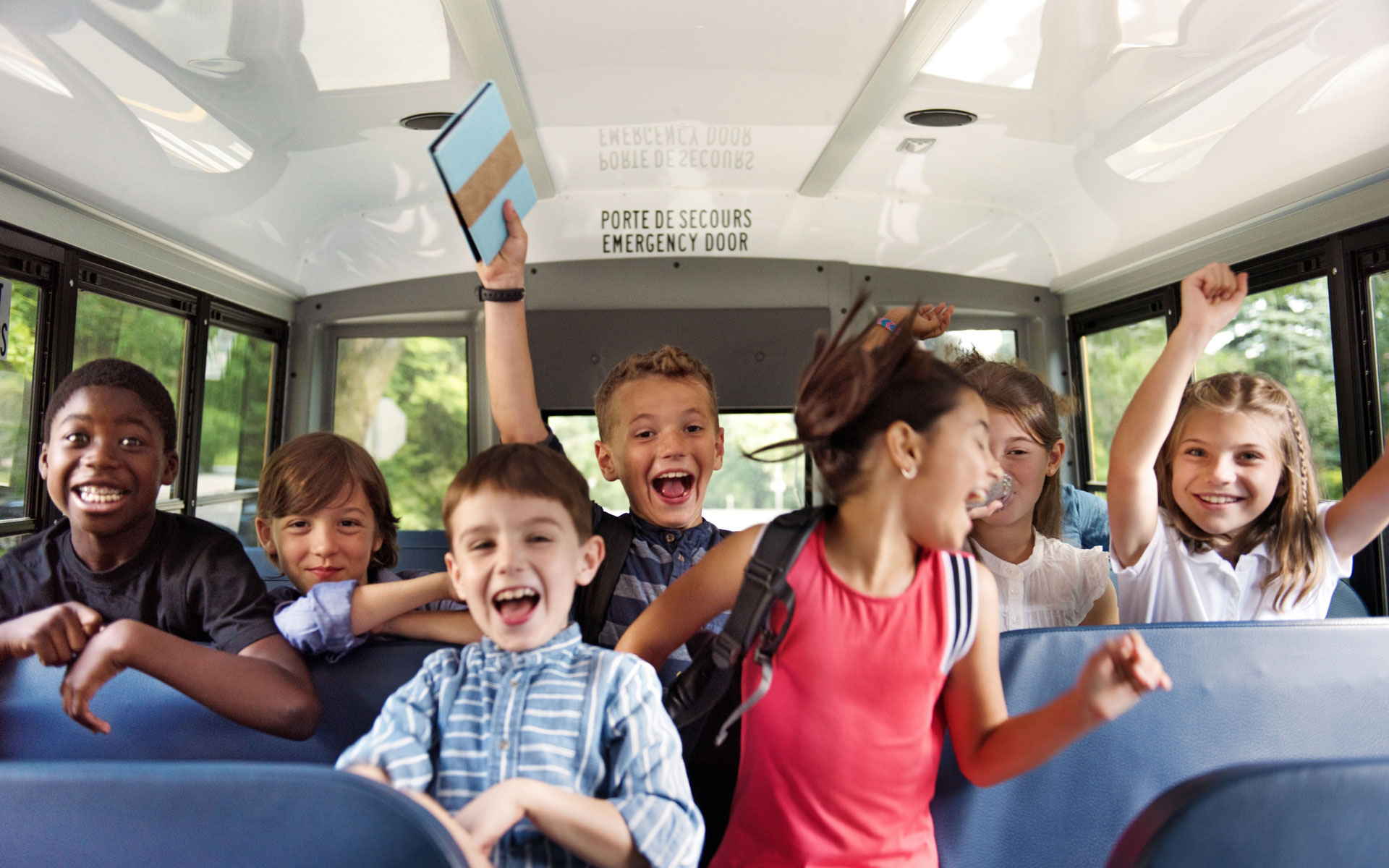 Cheering kids inside a bus