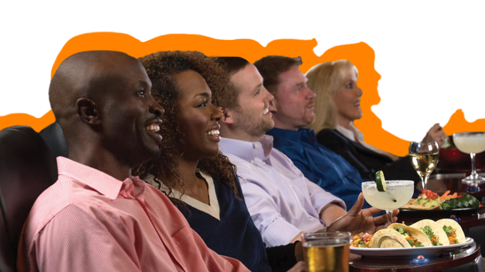 People eating and drinking in a movie theater