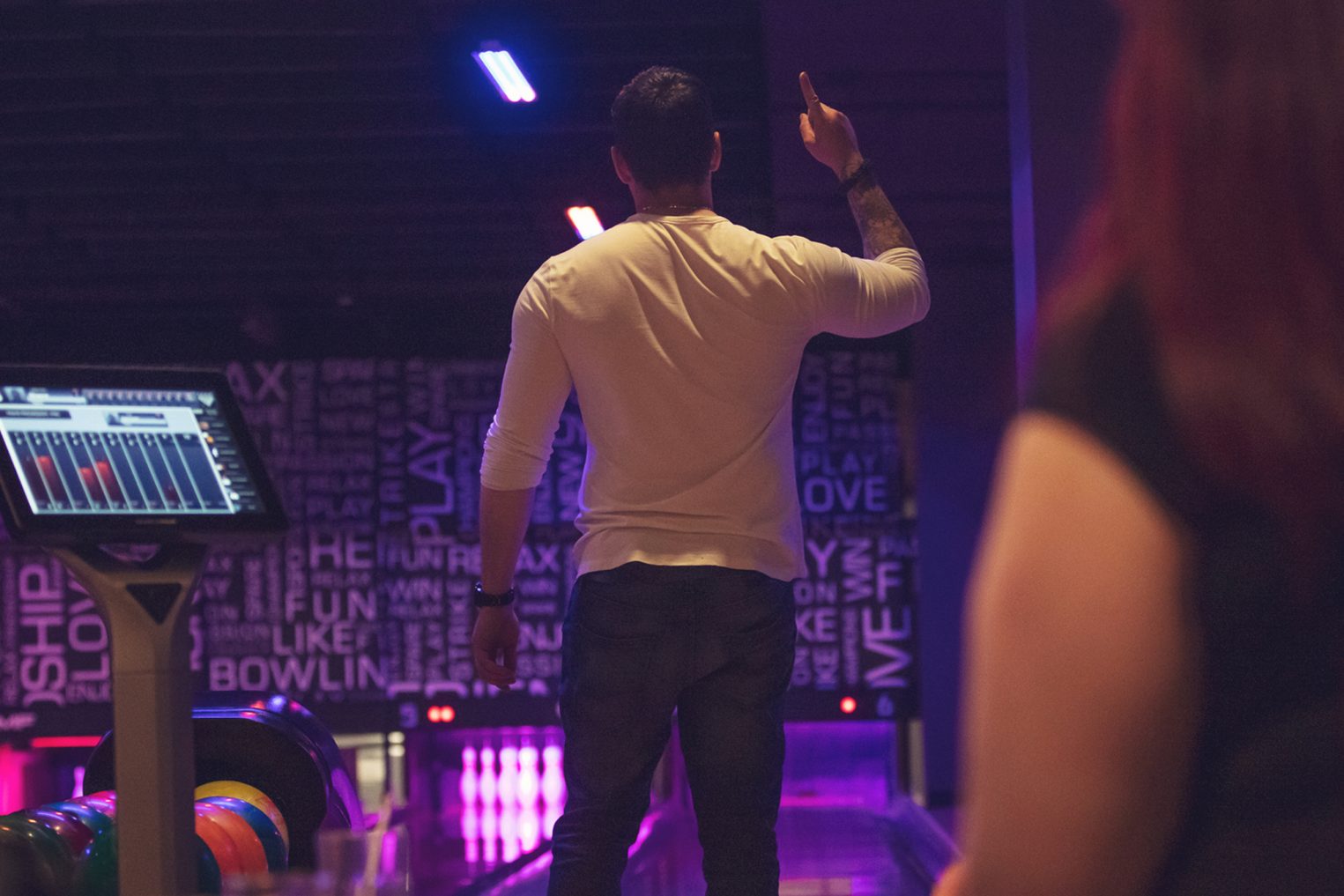 Man standing in bowling alley