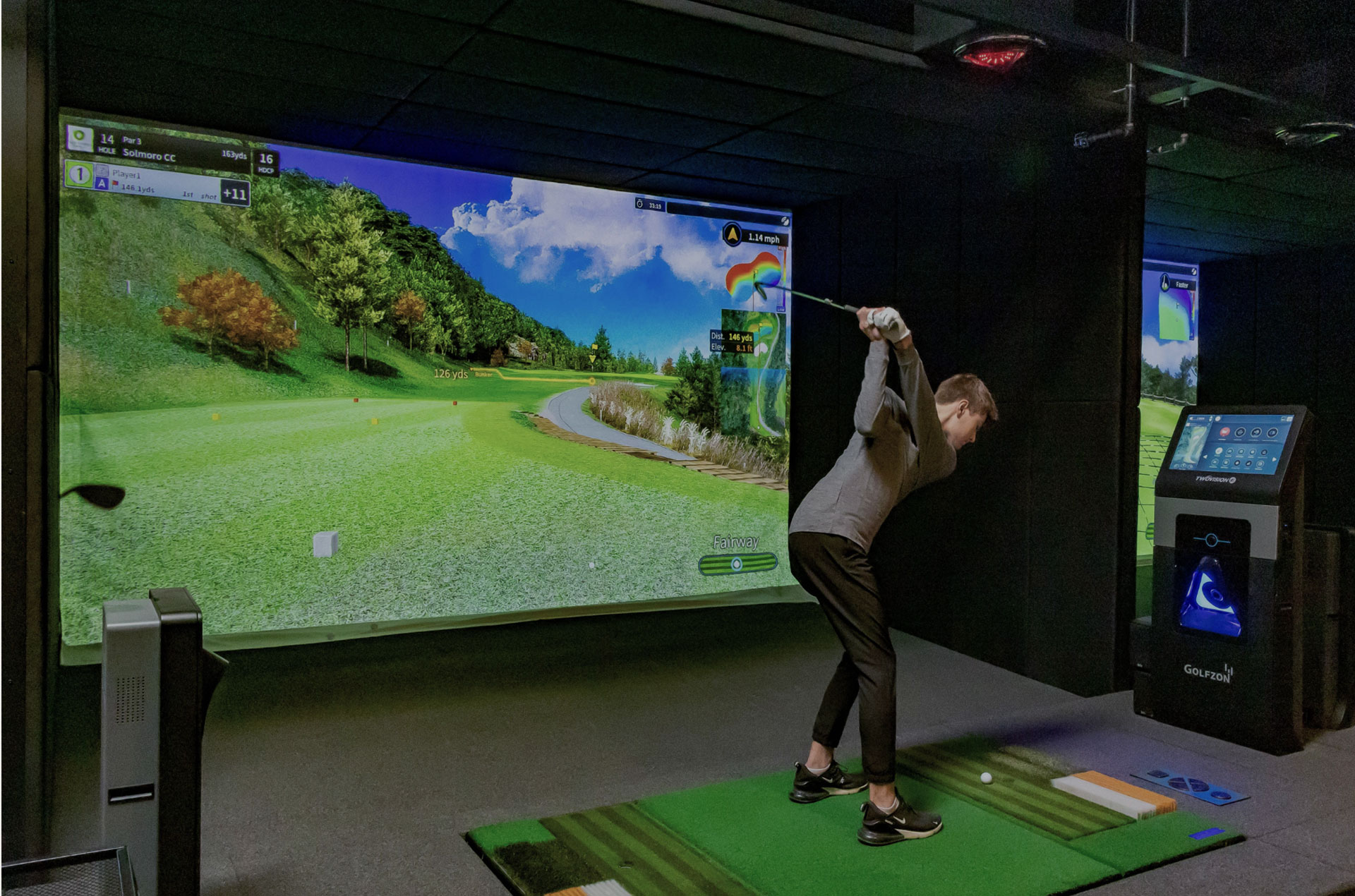 Person swinging a club at GOLFZONE