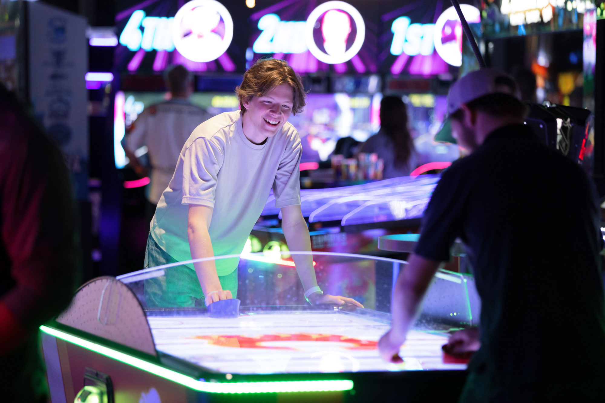 People playing air hockey