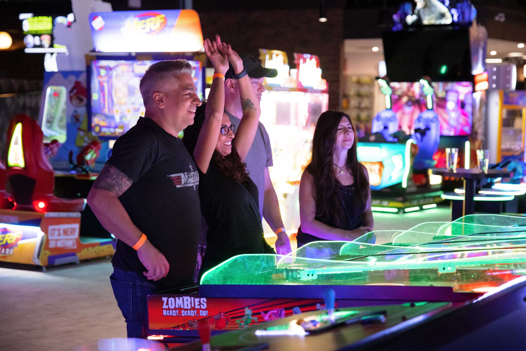 Adults playing arcade game