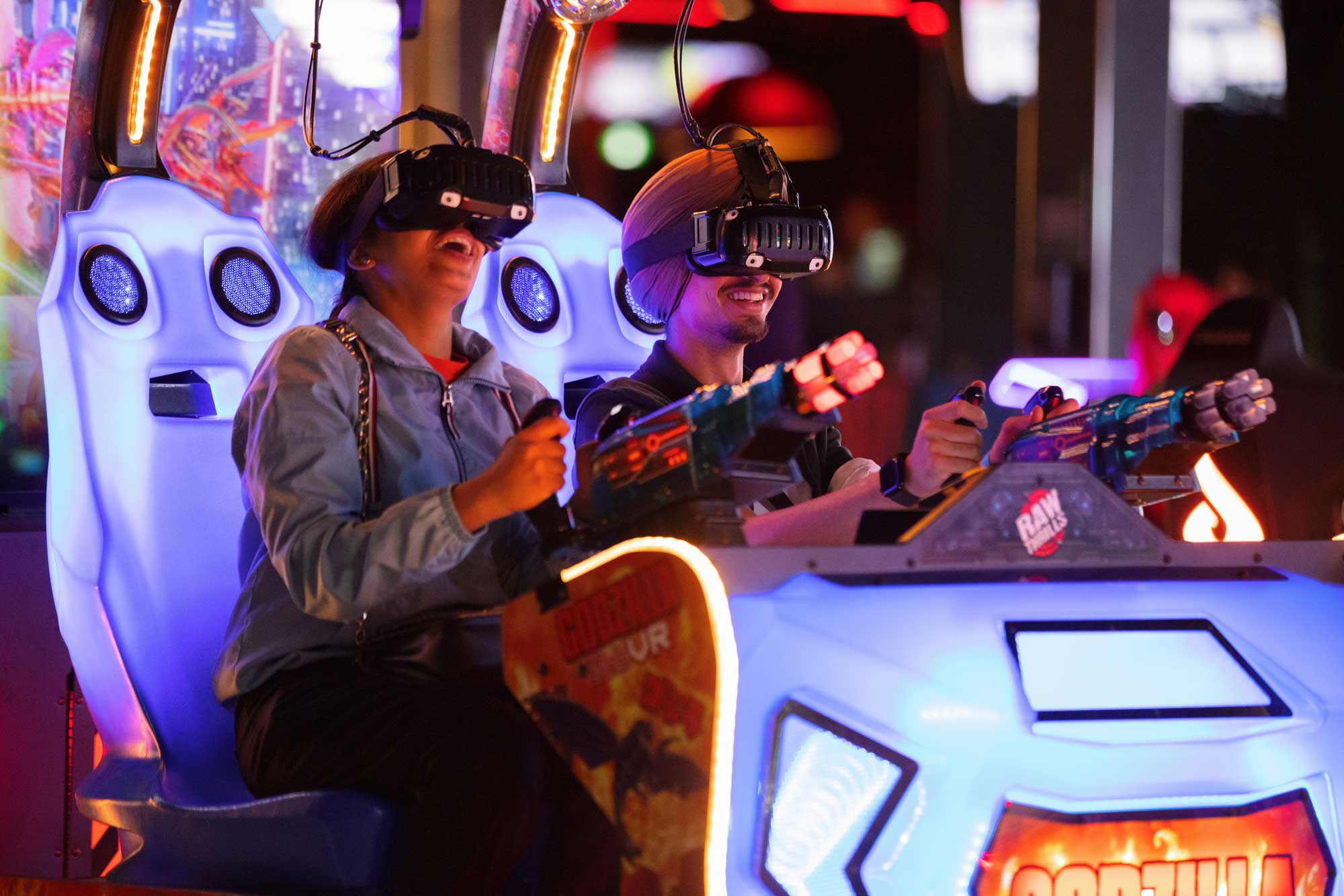 Two people playing a virtual reality arcade game