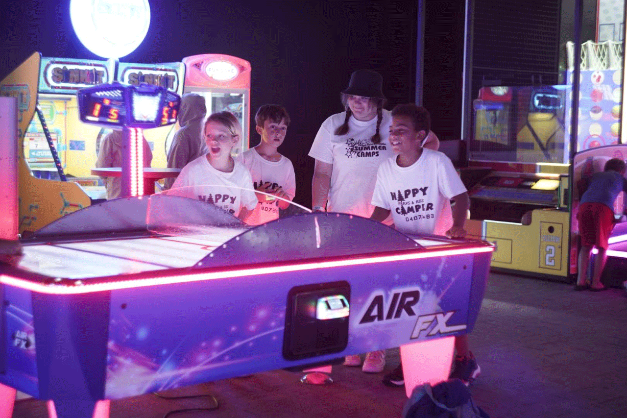 Kids playing air hockey