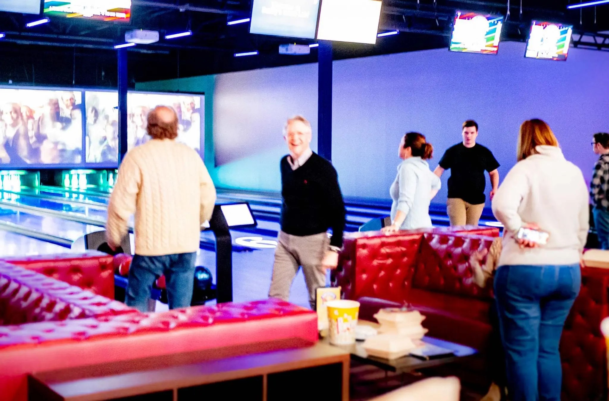 People standing around a bowling lounge