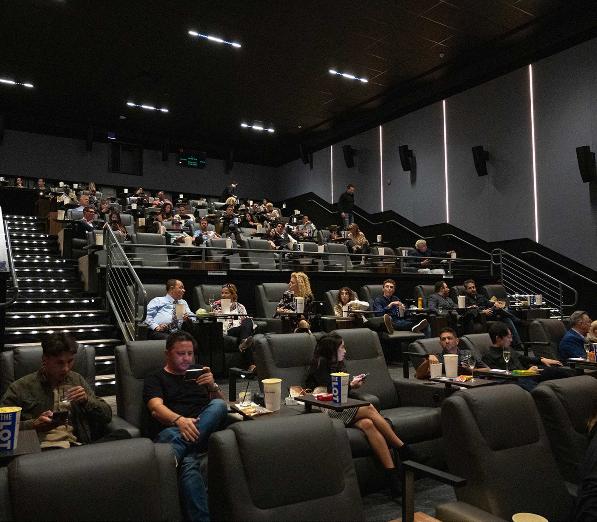 people sitting in a theater auditorium