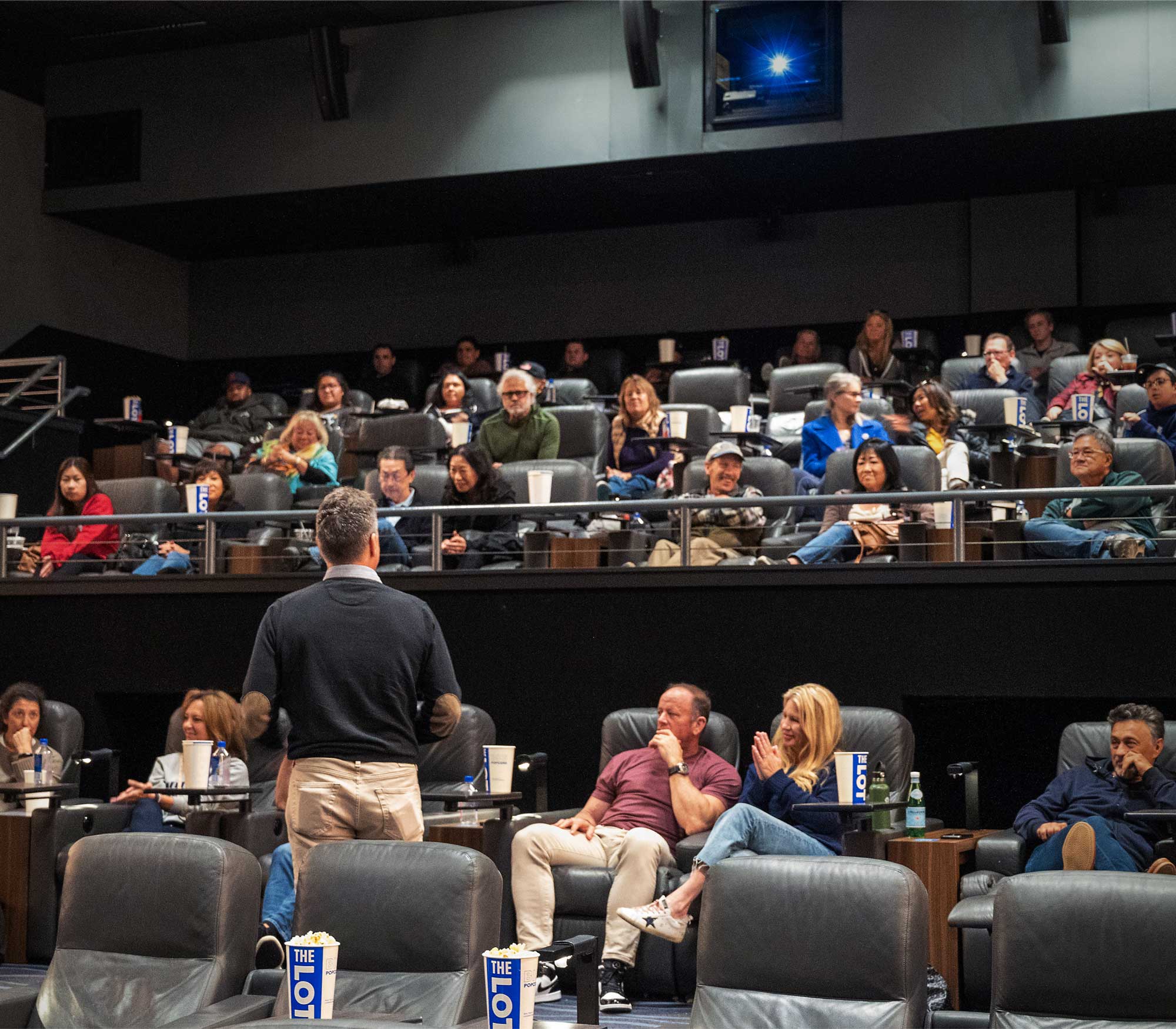 people sitting in a theater auditorium